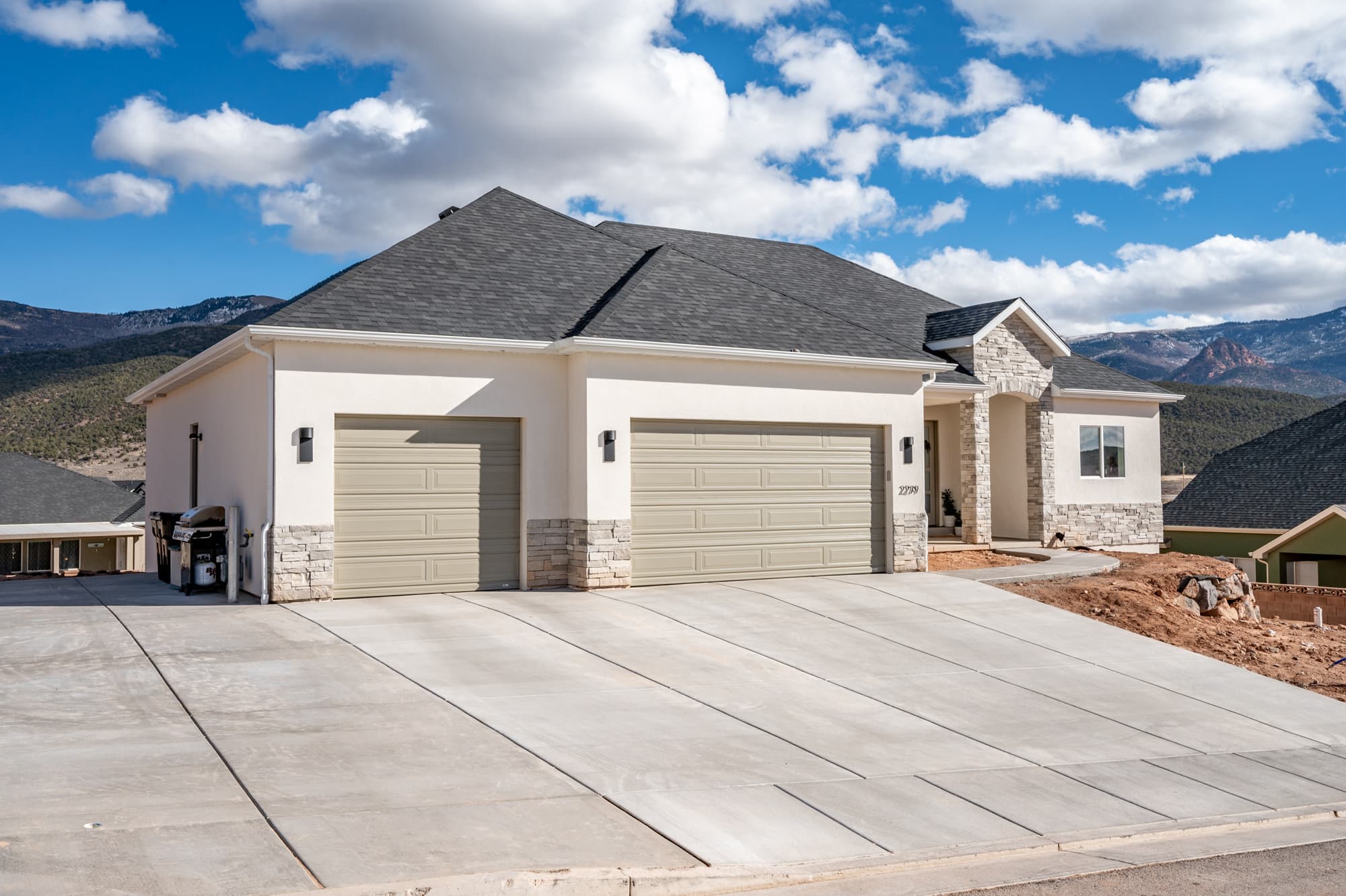 Front exterior with three-car garage and mountain views