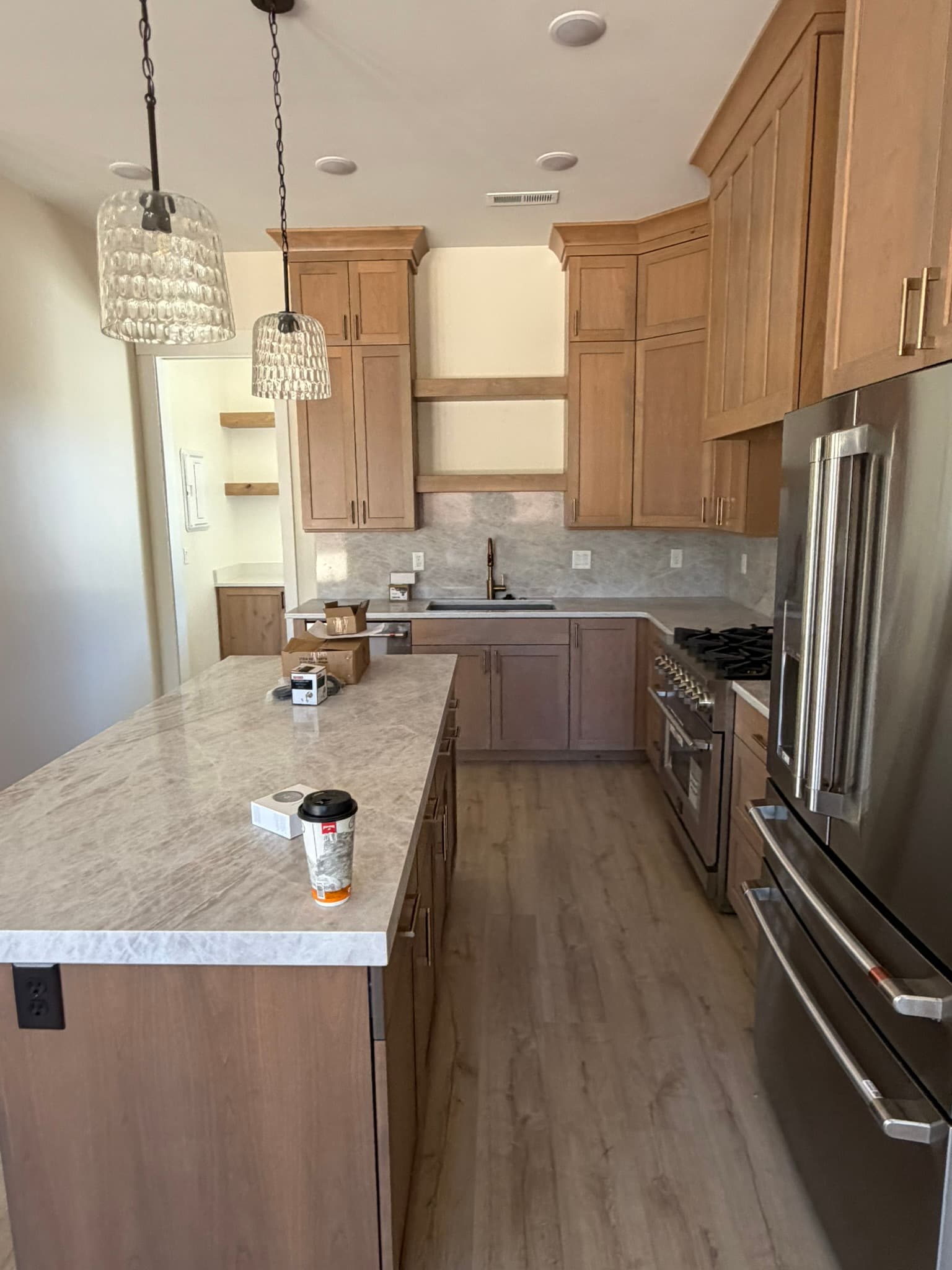 Kitchen with custom cabinetry and stone backsplash