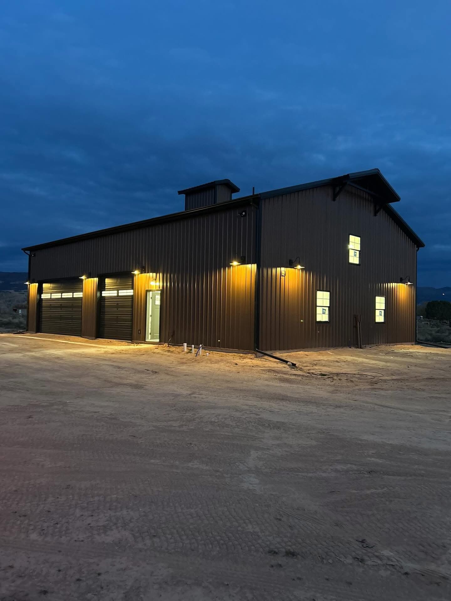 Steel shop at dusk with exterior lighting on