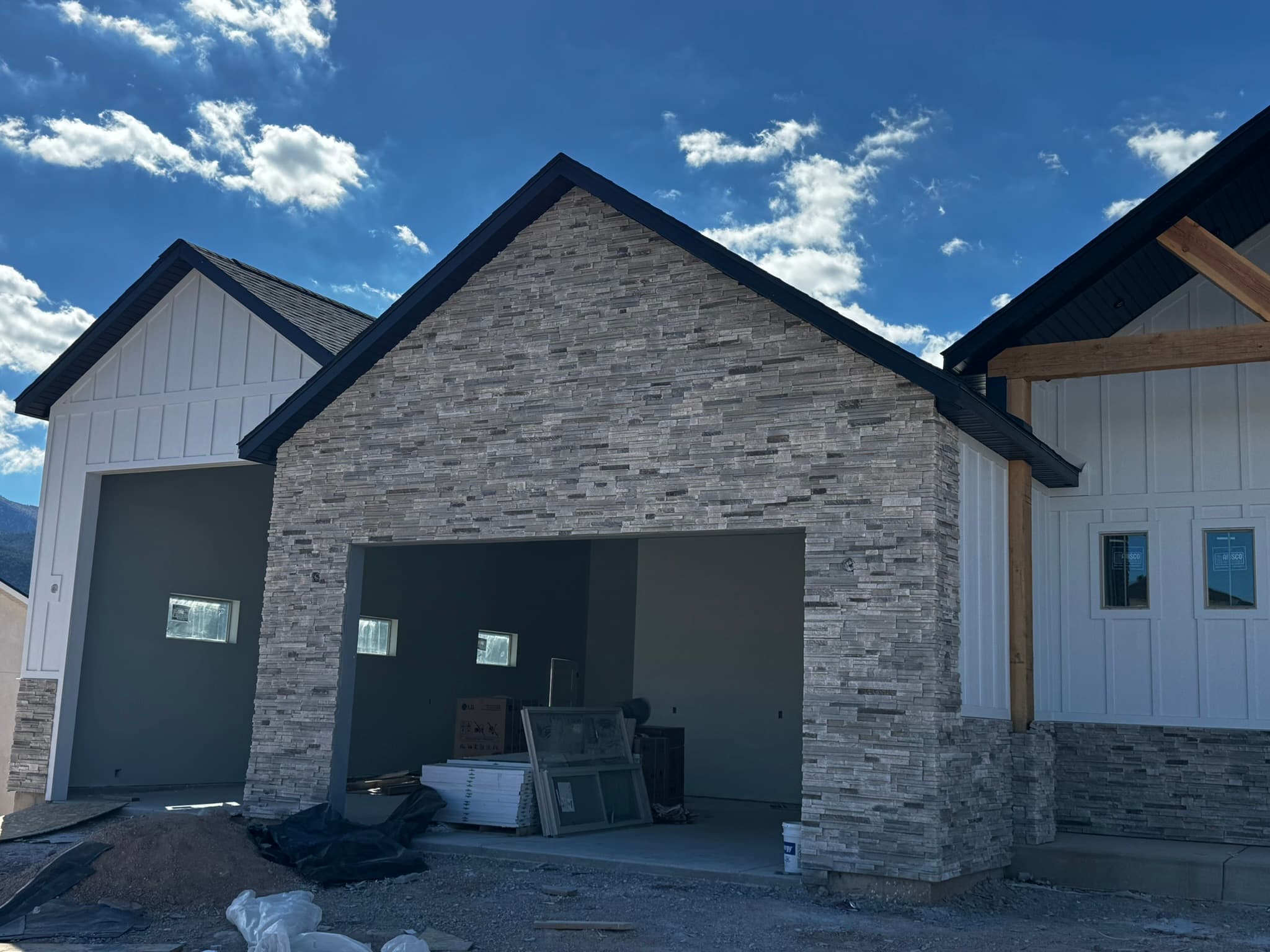 Modern farmhouse with stone and timber entry